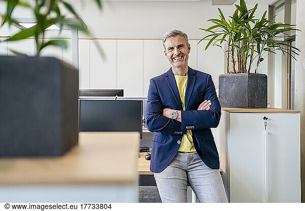 Portrait of happy mature businessman in office