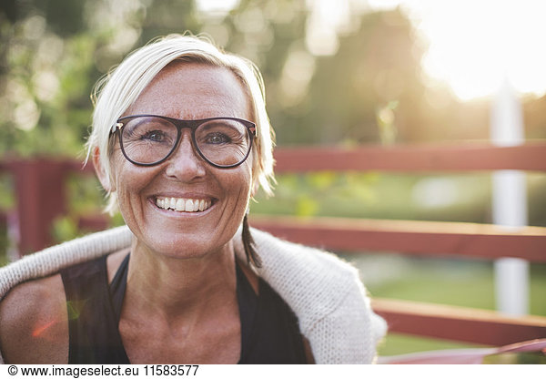 Portrait of happy mature woman in back yard