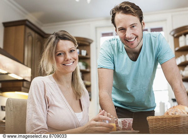 Portrait of happy mid adult couple in kitchen