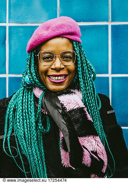 Portrait of happy mid adult woman with braided hair wearing pink beret