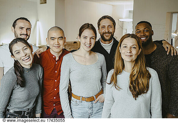 Portrait of happy multiracial male and female hackers in startup company