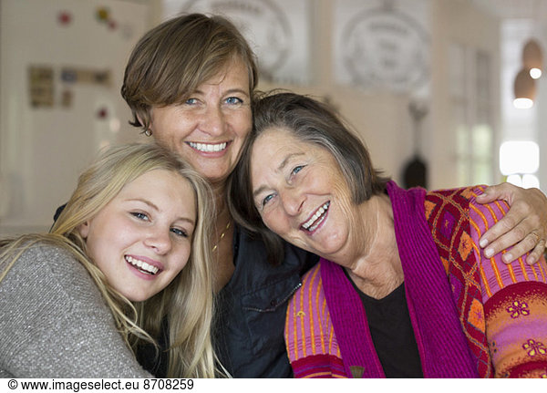 Portrait of happy three generation females at home