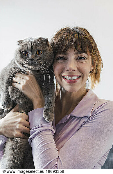 Portrait of happy woman with cat
