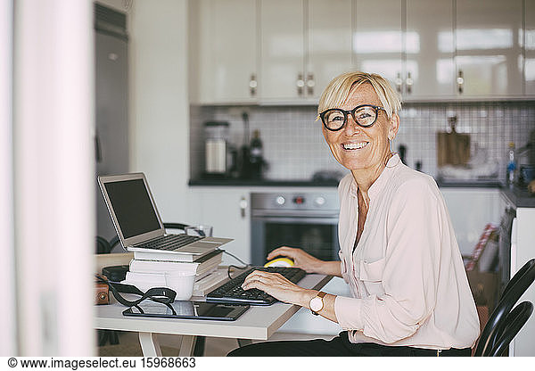 Portrait of happy woman working at home