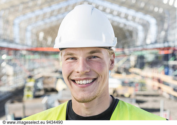 Portrait of happy worker at construction site