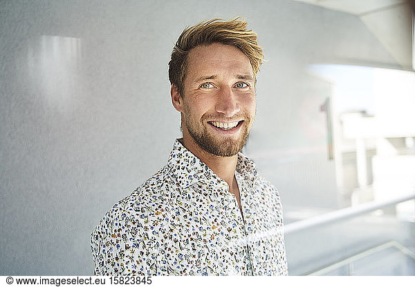 Portrait of happy young man wearing patterned shirt