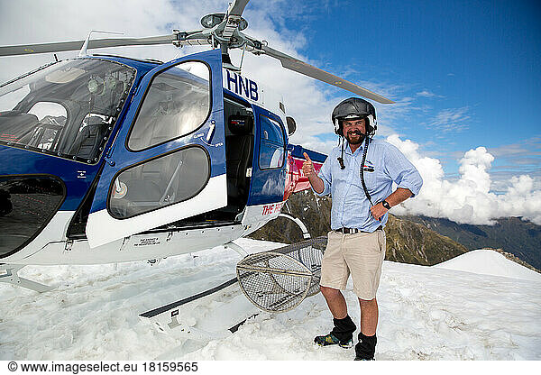 Portrait of helicopter pilot on top of Fox Glacier in New Zealand