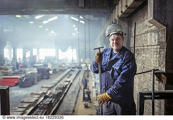 Portrait of iron foundry worker in iron foundry