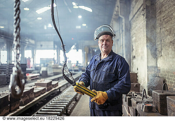 Portrait of iron foundry worker in iron foundry