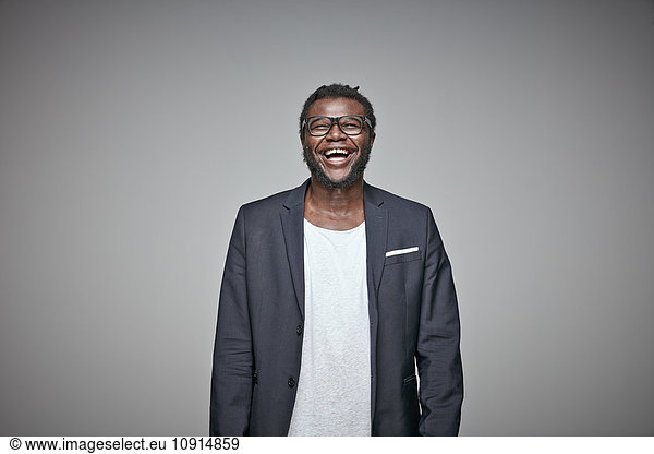 Portrait of laughing man wearing glasses and jacket