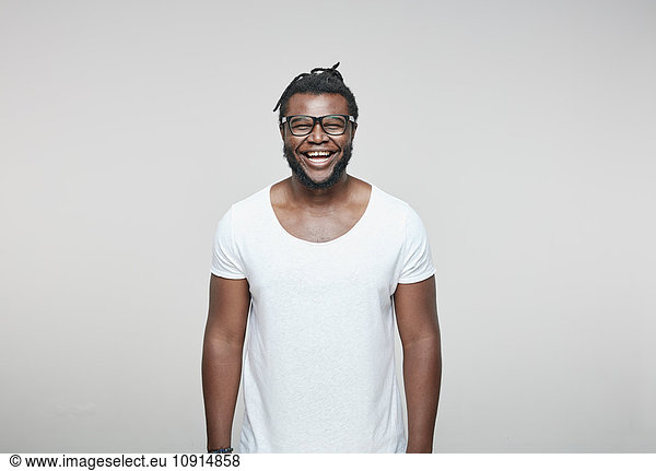 Portrait of laughing man wearing glasses and white t-shirt
