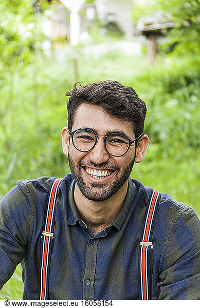 Portrait of laughing young man wearing glasses