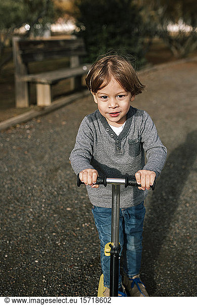 Portrait of little boy with scooter