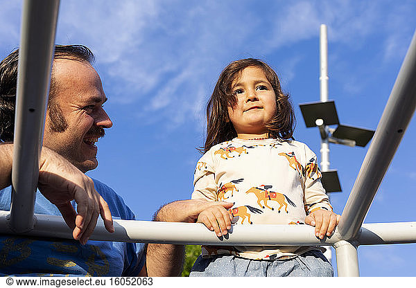 Portrait of little girl and her father on playground