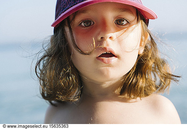 Portrait of little girl wearing cap on the beach