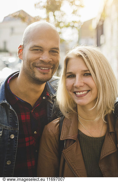 Portrait of loving couple smiling in city