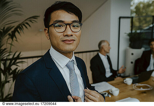 Portrait of male entrepreneur in board room at office