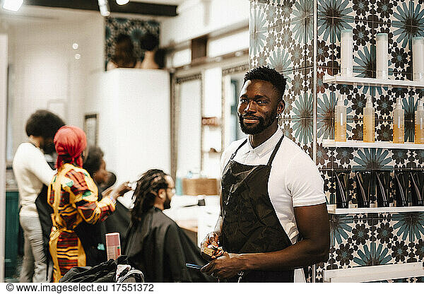 Portrait of male hairdresser standing in barber shop