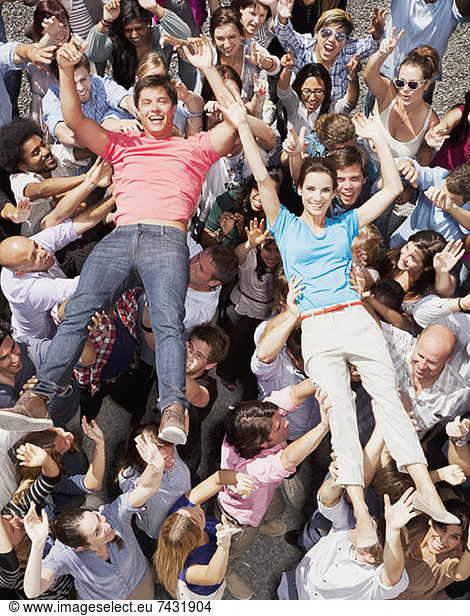 Portrait of man and woman crowd surfing