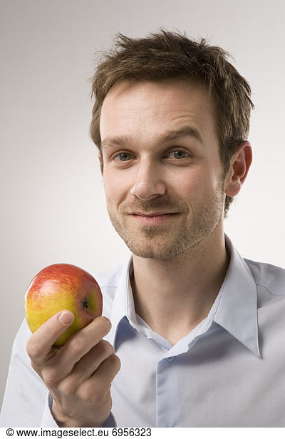 Portrait of Man Holding Apple