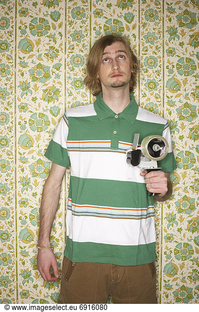 Portrait of Man Holding Tape Gun