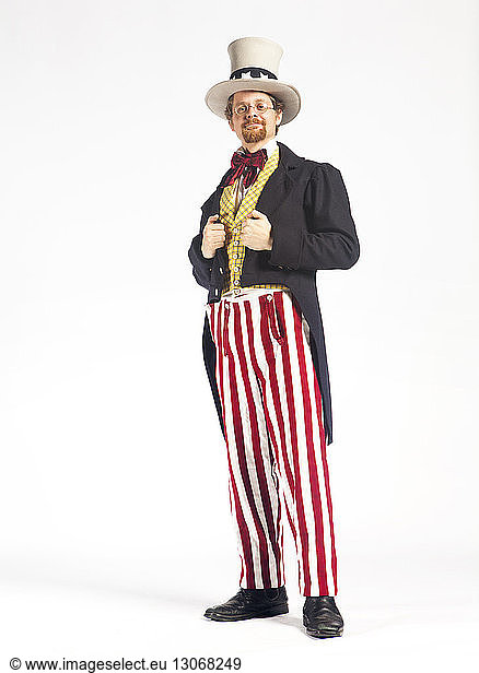 Portrait of man in uncle Sam costume against white background