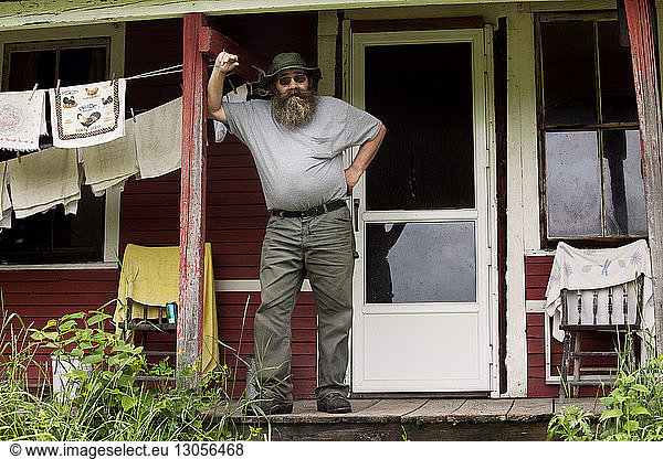 Portrait of man standing on porch