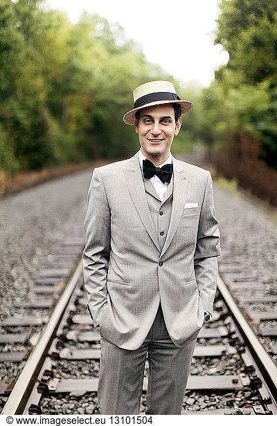 Portrait of man standing on railroad tracks
