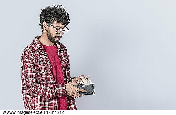 Portrait of man taking money out of his wallet  on isolated background  Person taking money out of his wallet on isolated background with copy space