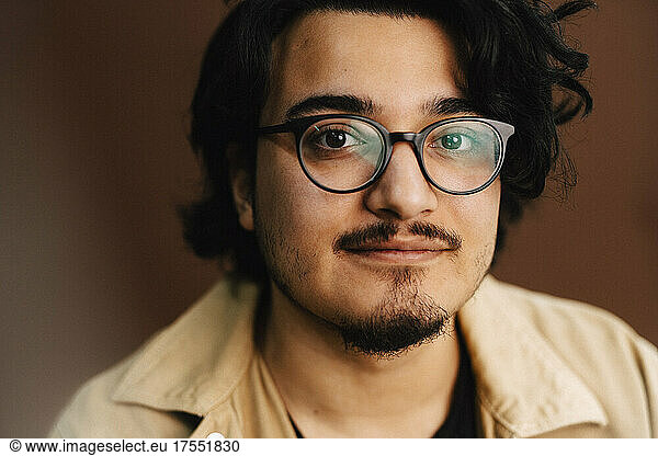 Portrait of man wearing eyeglasses in studio