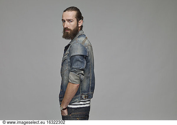 Portrait of man with full beard wearing jeans jacket