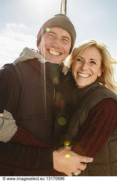 Portrait of mature couple outdoors  hugging  smiling
