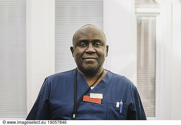 Portrait of mature male doctor with shaved head at hospital