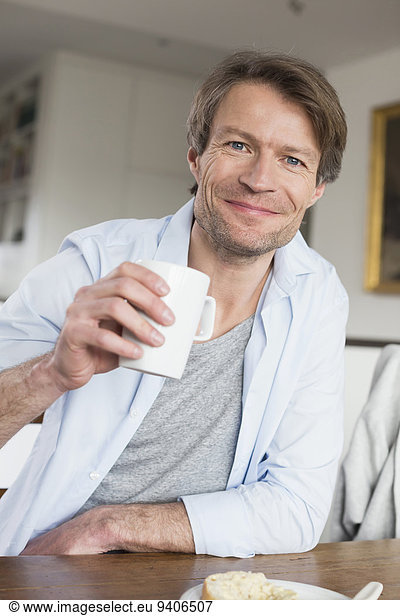 Portrait of mature man having coffee  smiling
