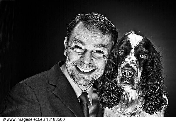 Portrait of mature man with English Springer Spaniel  smiling