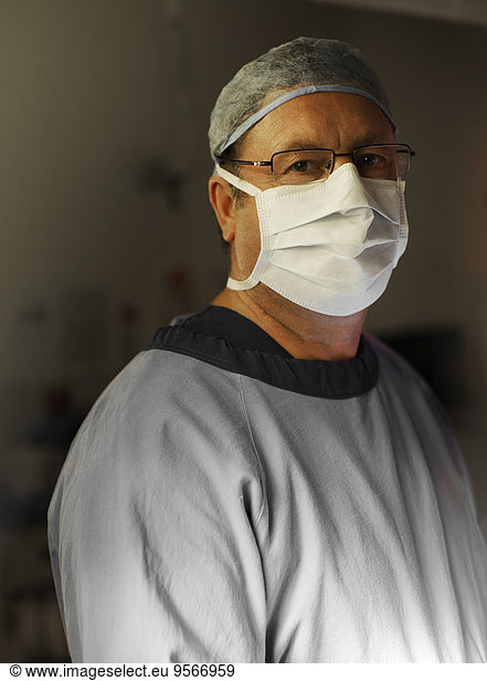 Portrait of mature surgeon by operating theater