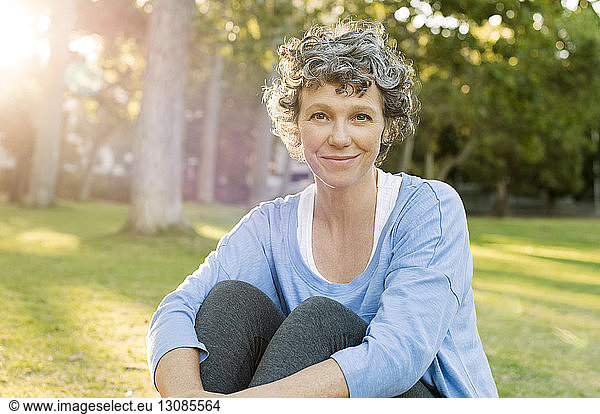 Portrait of mature woman sitting on field