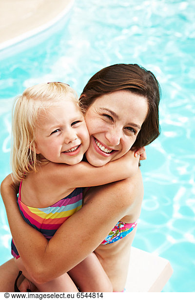 Portrait of mother with daughter in swimwear