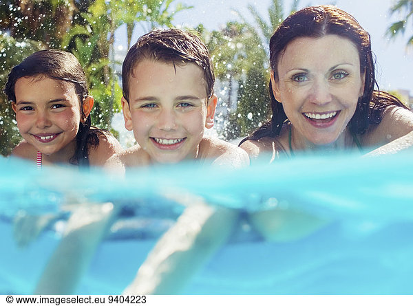 Portrait of mother with her two children in swimming pool