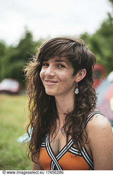 portrait of natural woman with long hair and freckles at festival