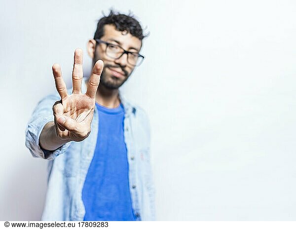Portrait of people counting number three on isolated background. Person hand counting number three. Handsome guy hand showing number three