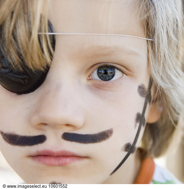 Portrait of pirate boy wearing eye patch