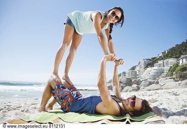 Portrait of playful couple on beach
