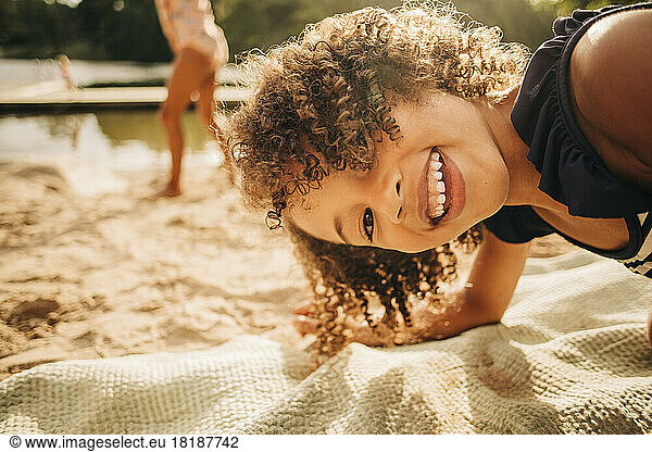 Portrait of playful girl with curly hair enjoying on vacation
