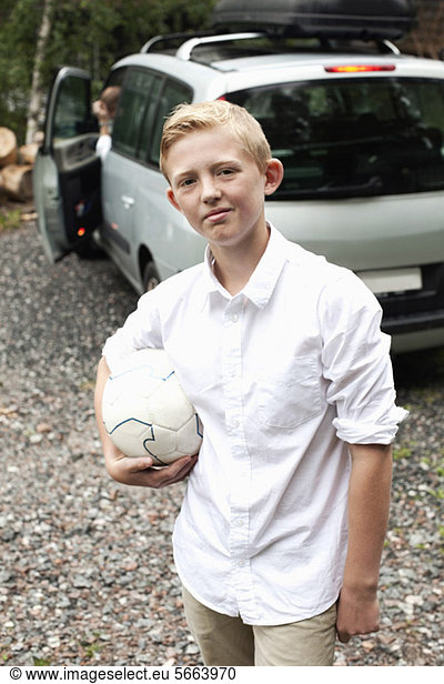 Portrait of pre-adolescent child holding soccer ball