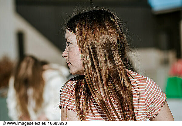 portrait of preteen girl looking away at someone