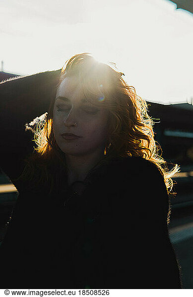 portrait of red-haired woman against sunset