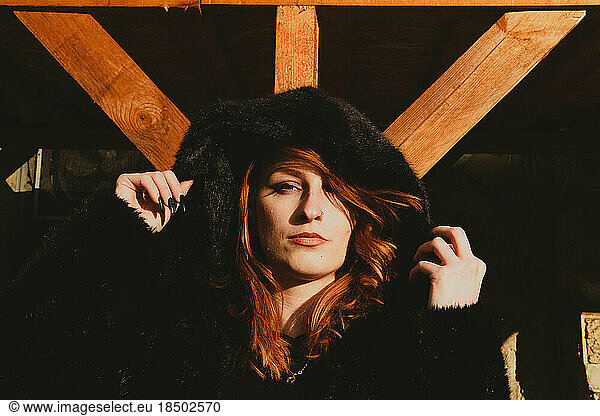 portrait of red-haired woman with hood