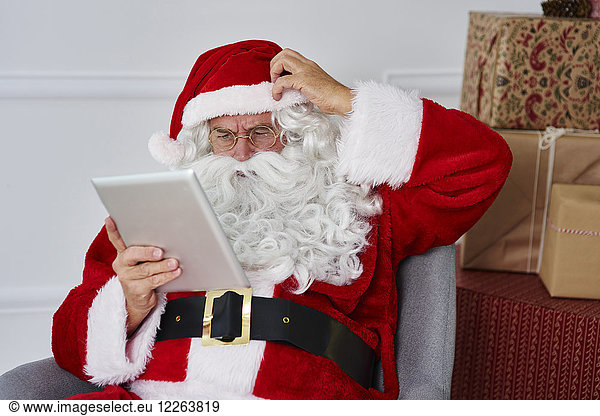 Portrait of Santa claus using tablet