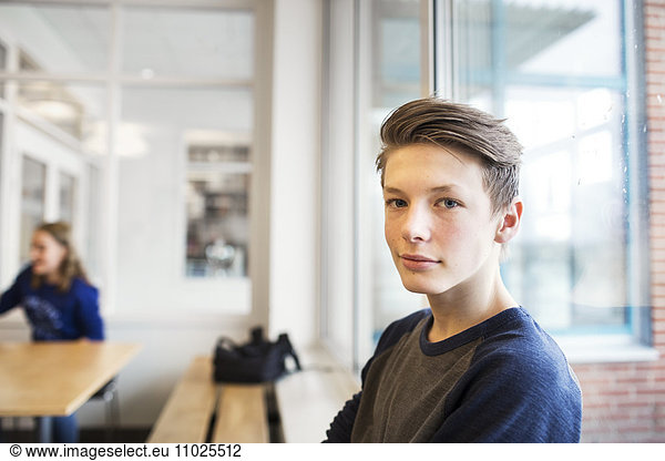 Portrait of schoolboy (12-13) looking at camera